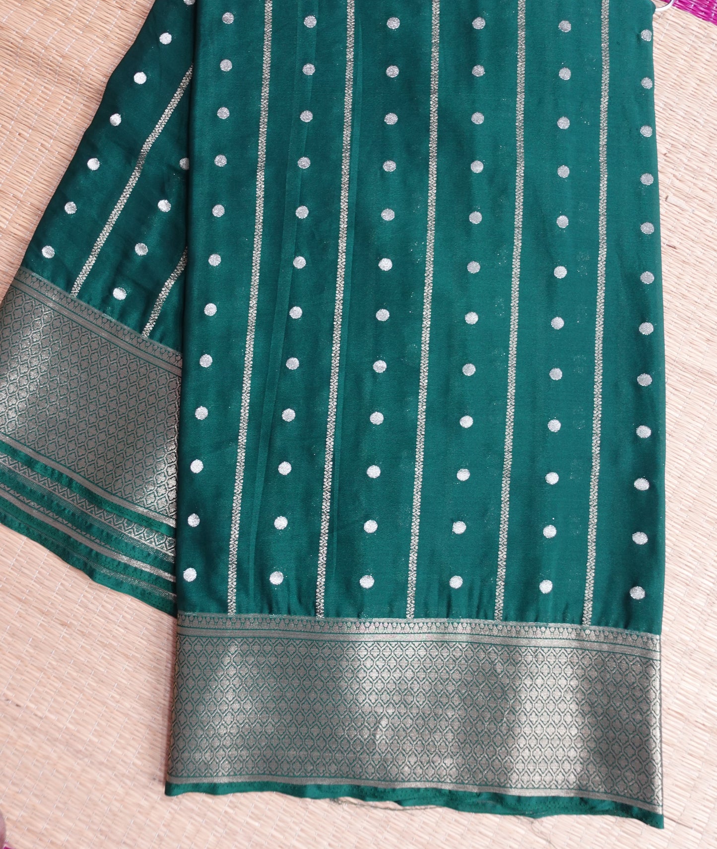 A bottle green colored crepe saree with 4-inch golden zari weaving (MCAUG131)