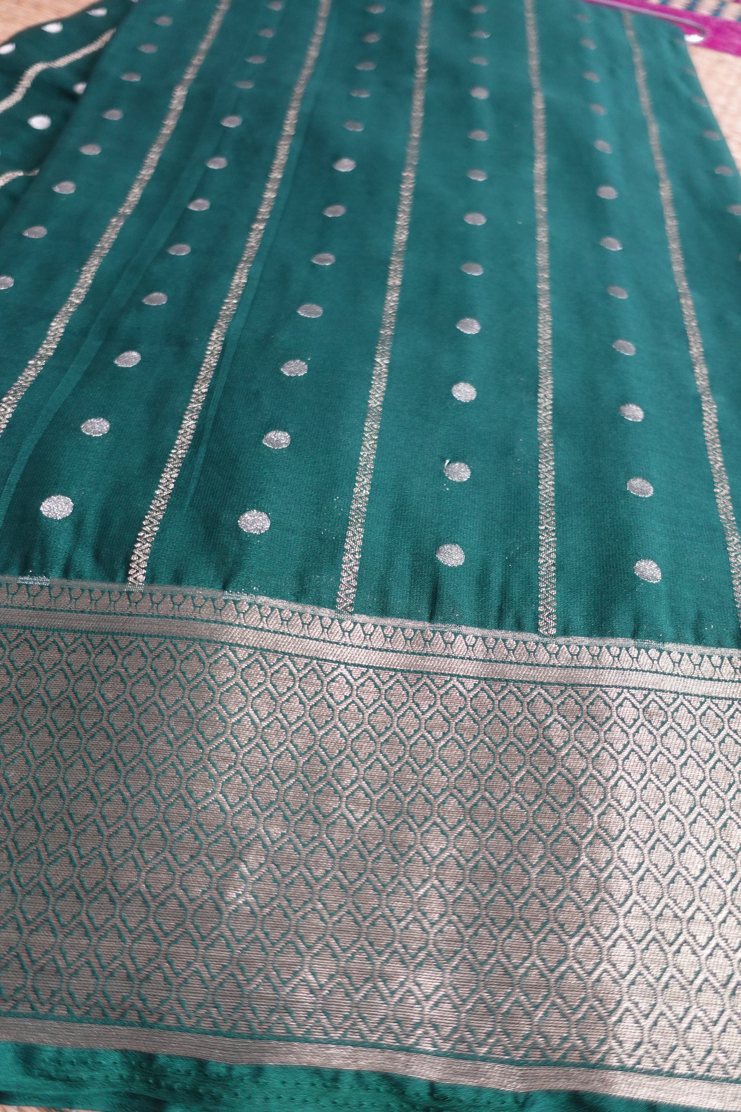 A bottle green colored crepe saree with 4-inch golden zari weaving (MCAUG131)