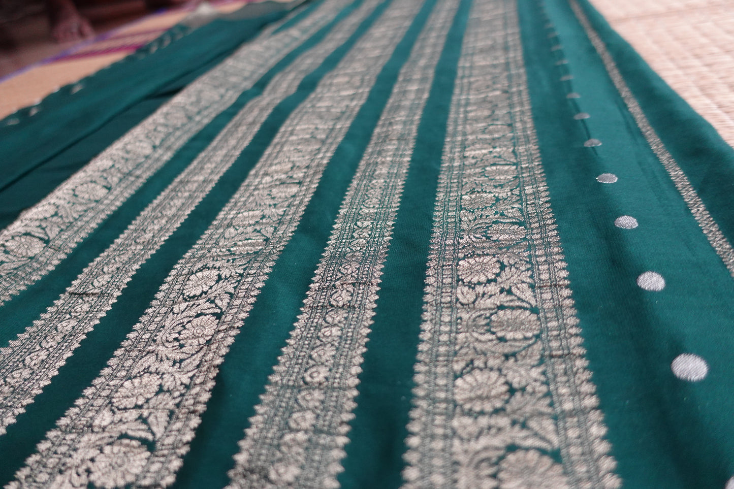 A bottle green colored crepe saree with 4-inch golden zari weaving (MCAUG131)