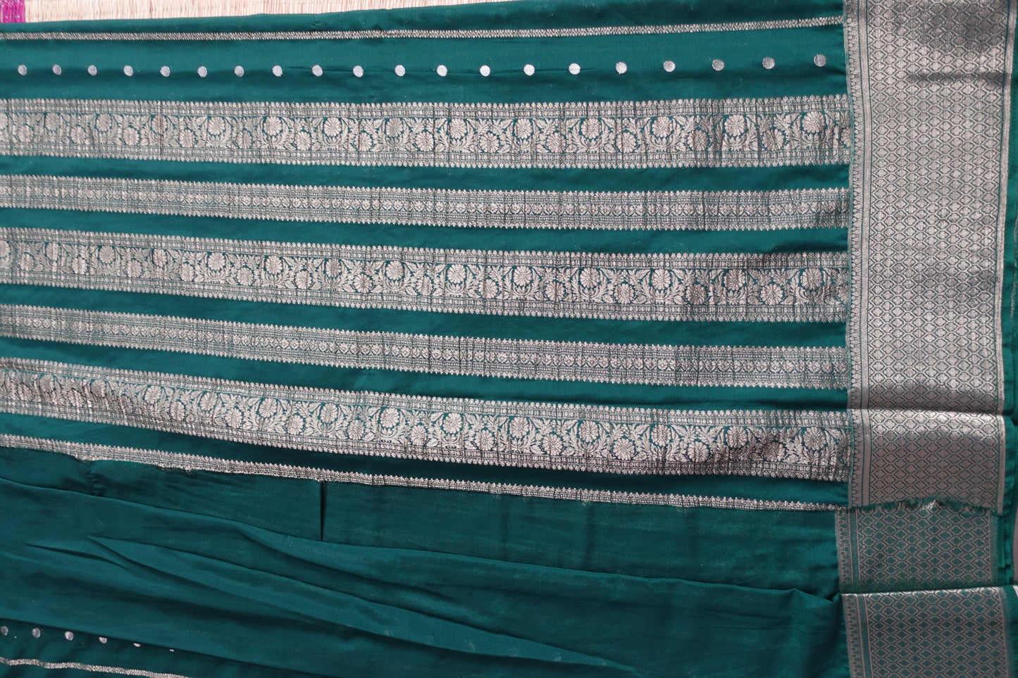 A bottle green colored crepe saree with 4-inch golden zari weaving (MCAUG131)