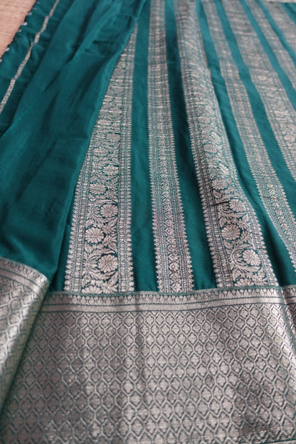 A bottle green colored crepe saree with 4-inch golden zari weaving (MCAUG131)